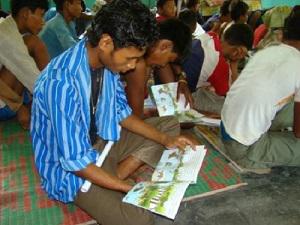 A student reads the booklet on Otters and freshwater ecosystem.