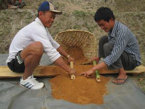 Grinding of clay to mix with the pest of charcoal for briquette production.