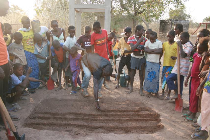 Students at Dar Salam school preparing seed beds for their school garden.