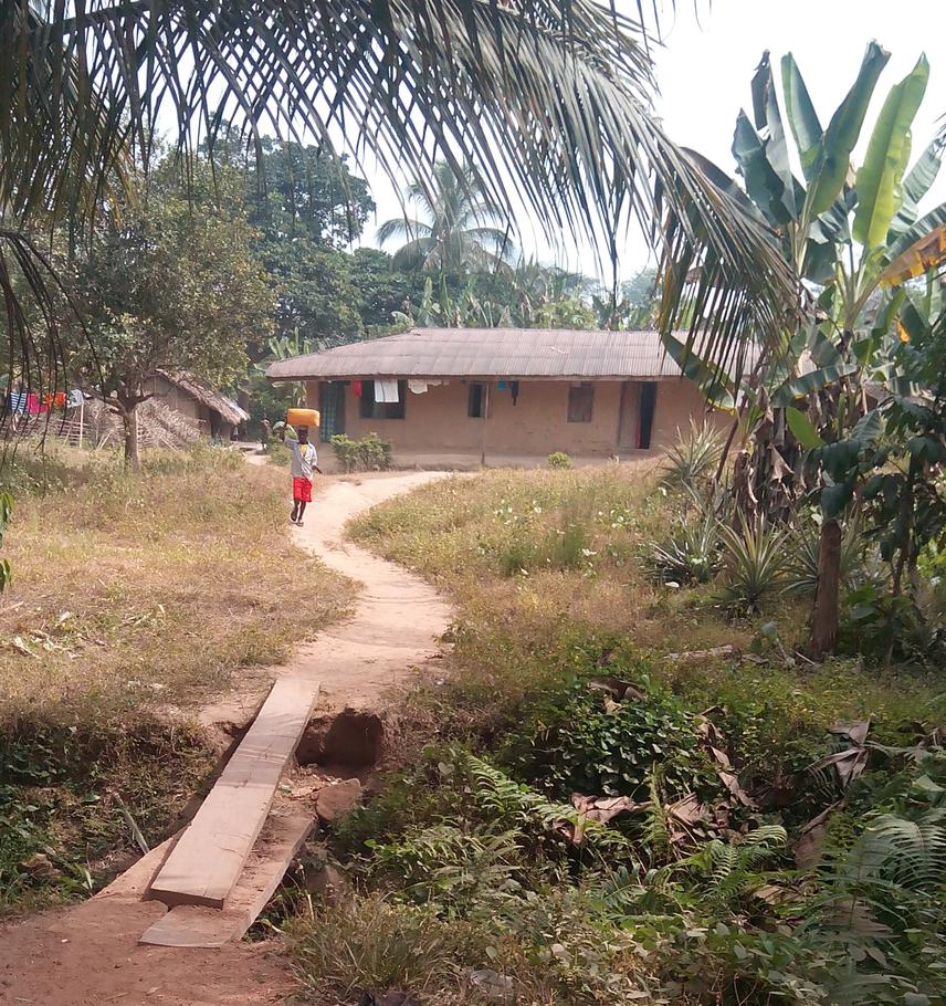 A young boy returning from fetching water in Iko Esai community.