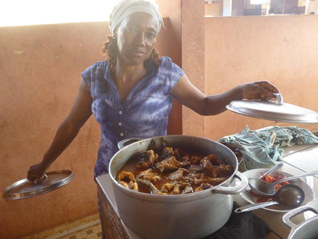 Bushmeat seller showing the menu.