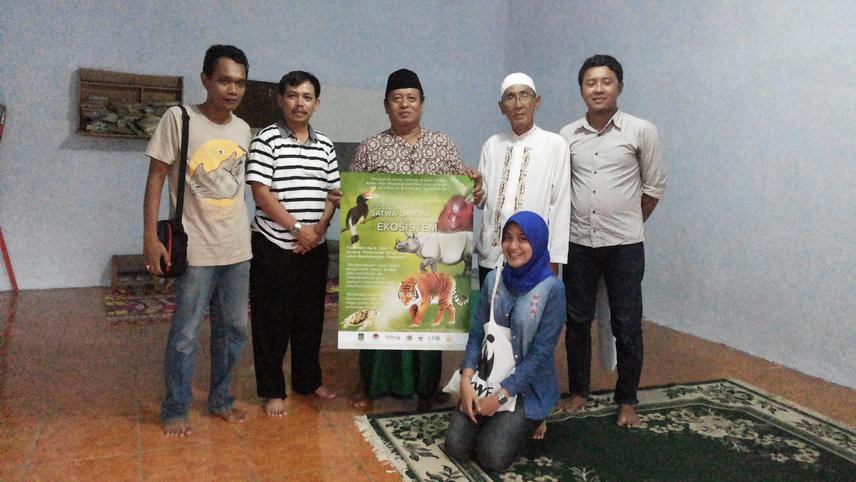 The Poster of Fatwa on Wildlife Protection (held by a   clerics and village elder)  disseminated in Ujung Kulon, West   Java by WWF Indonesia Staff.