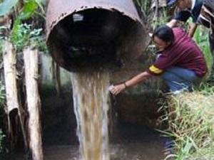 Student taking wastewater from the MSG factory outlet.