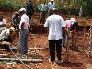 Community members are busy filling up animal pit traps that were dag by farmers.