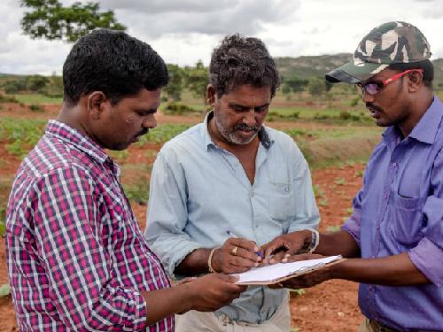 Wild Seve field assistant (right) using the pen and paper method to record villagers’ complaints of crop damage by wildlife. Data are now recorded electronically. ©CWS.
