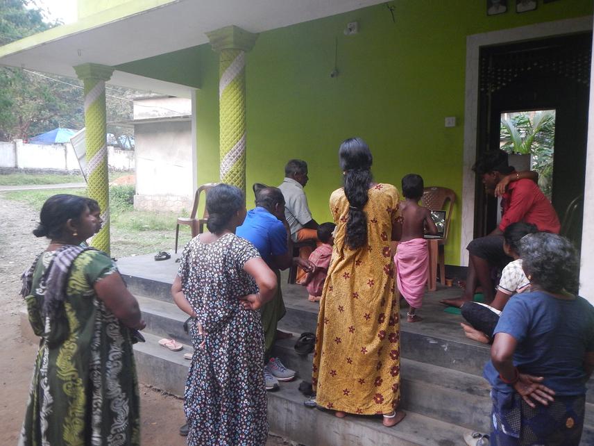 Adults of Vazhachal settlement watching the documentary made about frogs