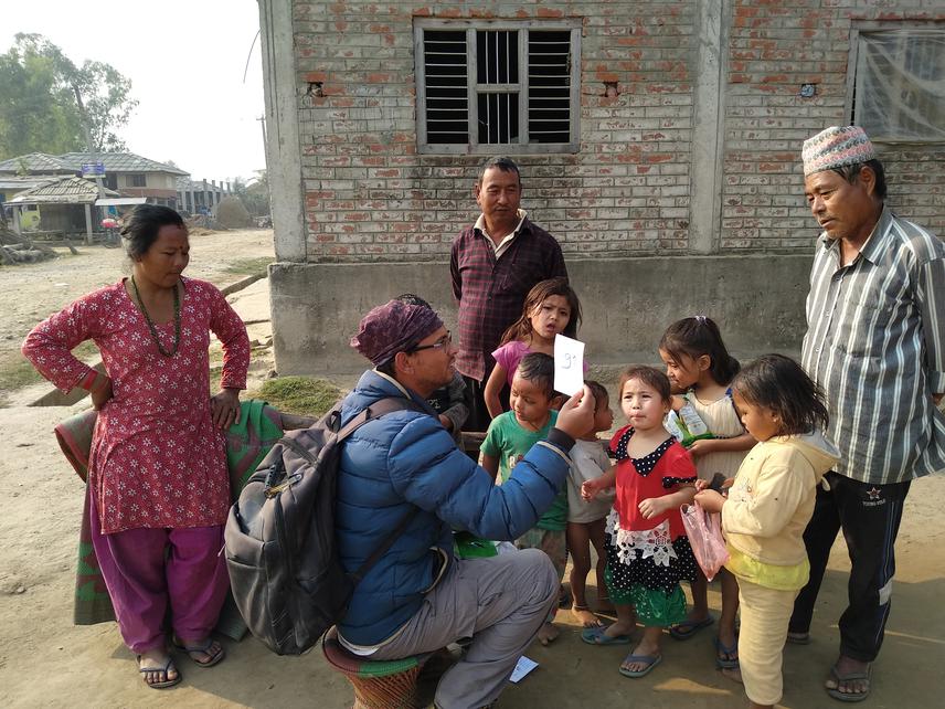 Awareness program to farmers and children by showing farmland bird photo.