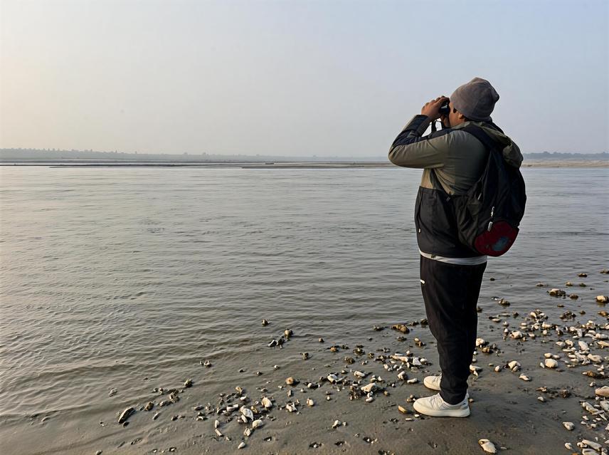Project lead Laba KC monitoring river dolphin habitat Koshi River (C) Bimal Timsina