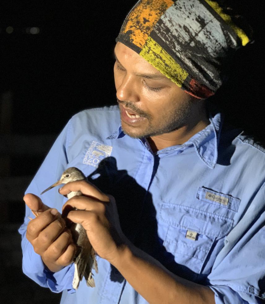 Sayam with a Common Redshank. © Nazim Uddin Khan.