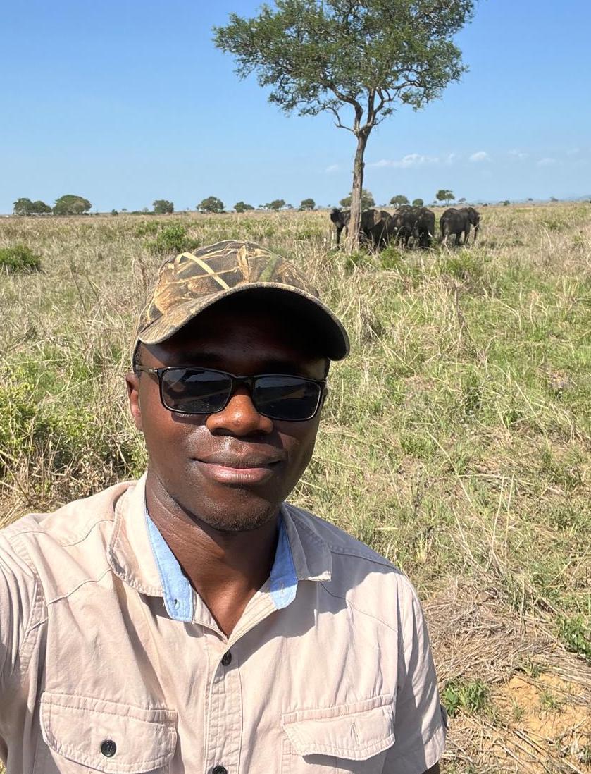 Felician pictured with elephants at Mikumi National Park. © Felician Ezekiel.