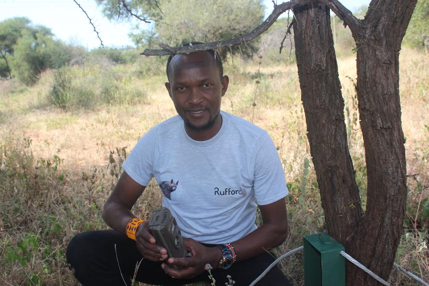 Justine setting camera traps in the field. ©Edward Philipo.