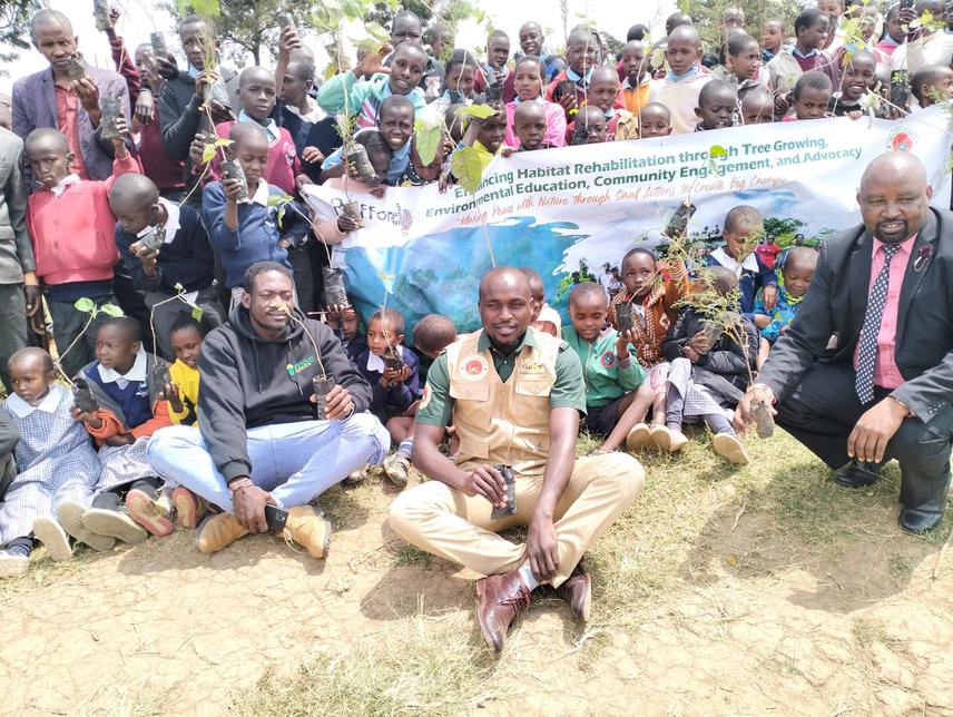 JS Ole Naeku Primary School students pose for a photo with our project team prior to tree planting session. © Ouya, 2024.