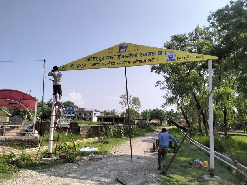 Local installing a gate in the community led homestay in Jagdishpur. The gate was installed with the aim of promoting fishing cat conservation. ©Naresh Tharu.