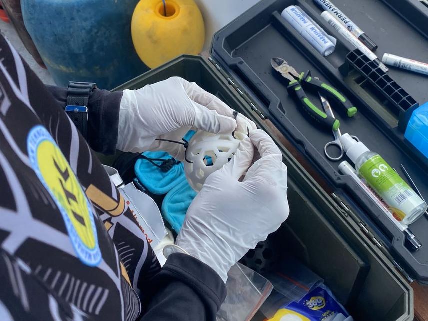Rofi preparing eDNA sampling tools. © Laudy Zufar Makarim