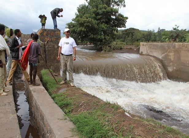 The principal investigator and a graduate student, Gizachew Teshome, at a newly constructed small dam and diversion canal on Shini River.