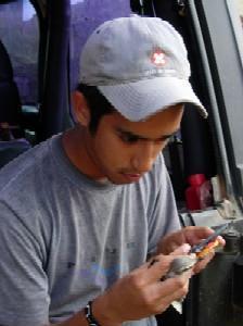 Undergraduate biology student taking bird measurements.