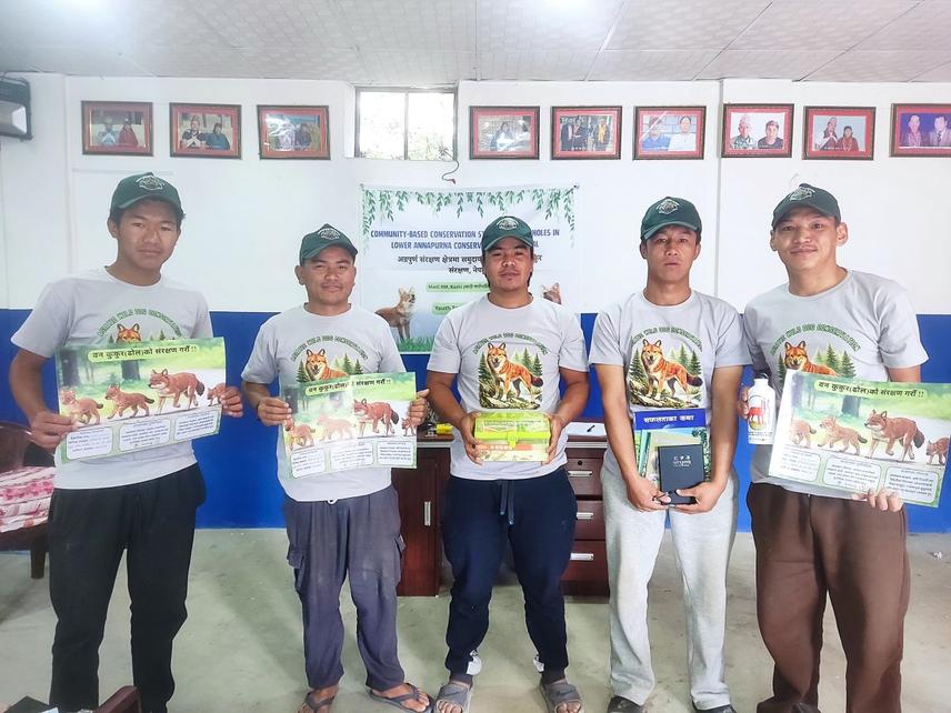 Youth participants displaying educational materials following a training session aimed at strengthening local conservation leadership for dhole conservation in Sikles. © Prabal Bir Jung Rana