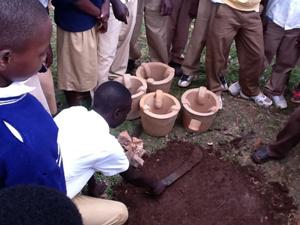 Outdoor training of installation of improved cooking stoves.