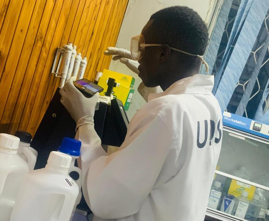 A researcher carefully processes giraffe faecal samples © Meshack Lutoba Madata.