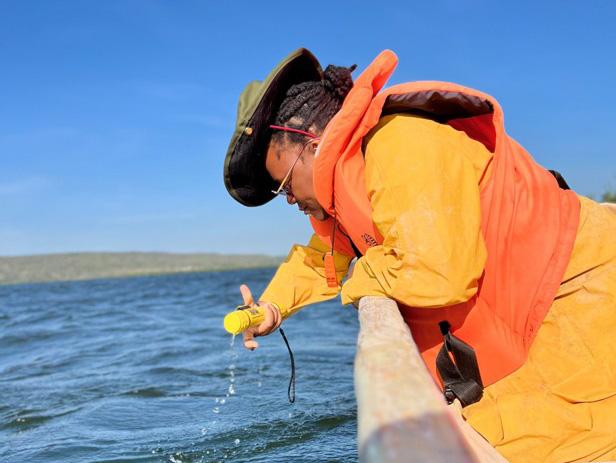 Measuring water depth prior to deploying the fishing net to ensure suitable sampling conditions, thereby determining the precise depth at which Haplochromis microdon was caught. (c) Naomi Njarabi
